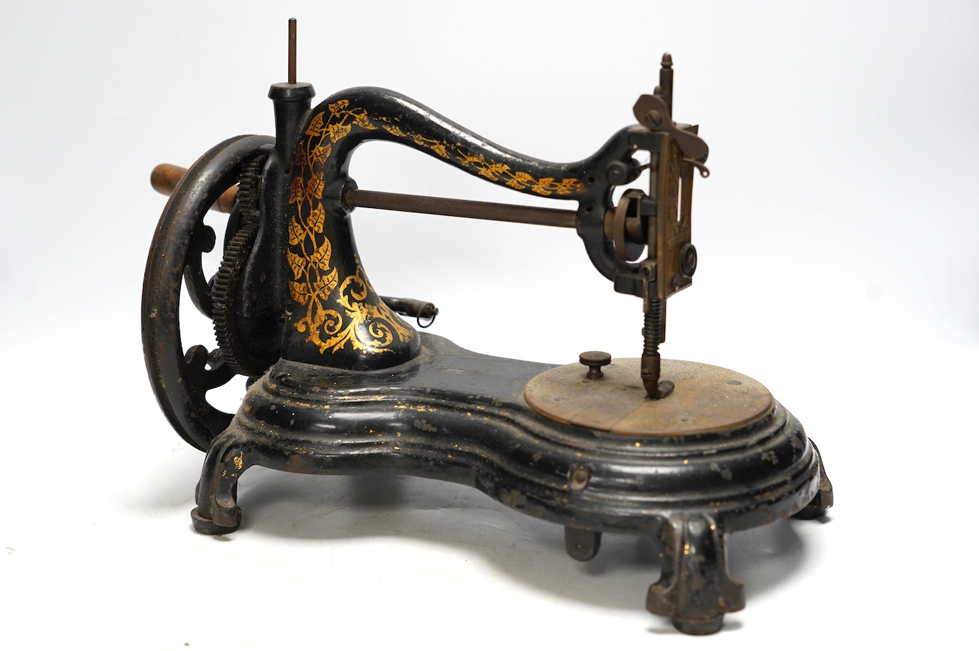 A late 19th century Jones swan neck sewing machine, with cast iron base and gilt ivy decoration to the frame. Condition - fair